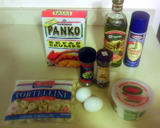 Gather ingredients: ravioli or tortellini, panko crumbs, cheese, spray oil, two eggs, oregano, and red pepper flakes.