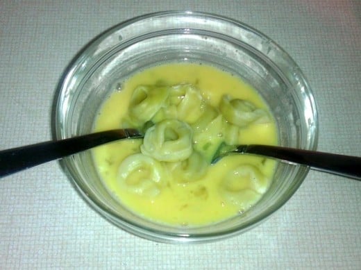 Separate the individual tortellini and dip into the egg...