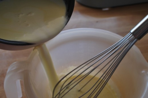 Slowly pour the warmed cream into the eggs, whisking continuously.   Then return the egg and cream mix to the pan.
