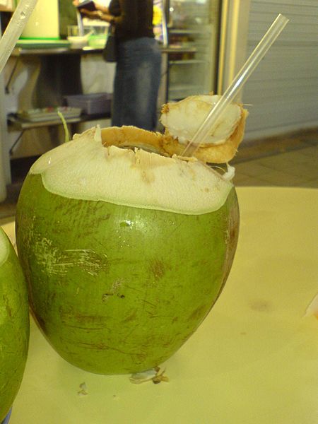 coconut water being drunk from the fruit