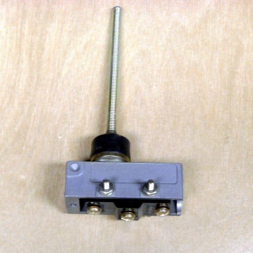 This specialty switch is operated by something moving the long 6" rod at the top.  It operates either of two loads, thus has 2 load wire terminals and a line terminal.