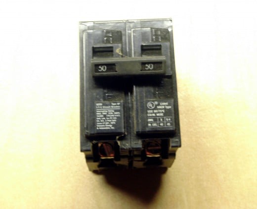 A circuit breaker.  A switch that will turn off either manually or automatically if the current passing through it exceeds a set limit (50 amps in this case).  This one controls two different circuits at the same time.
