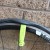 Pull the tire lever down to unhook the tire bead and if possible hook the tire lever around a spoke