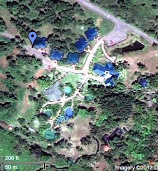 A satellite-eye's view of Blue River Resort, showing the 5 pools, cabins and the spa building.