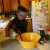 My four year old pours the tomato sauce into a large mixing bowl. My four year old pours the tomato sauce into a large mixing bowl.