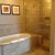 Both the bathtub and shower areas are large and lined in marble and stone tiled. Both the bathtub and shower areas are large and lined in marble and stone tiled.