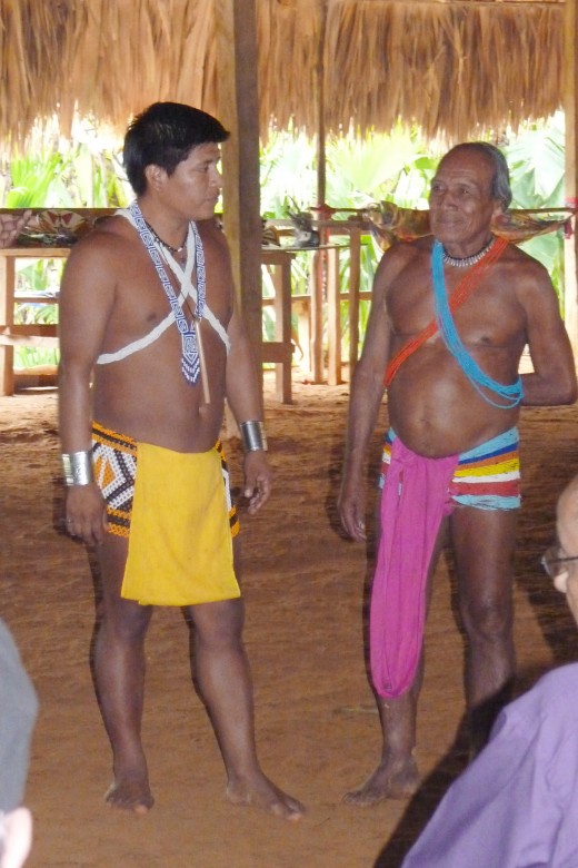 Embera Indian Chief, left side, and person responsible for all the building construction in their village, on right side, answering our questions.