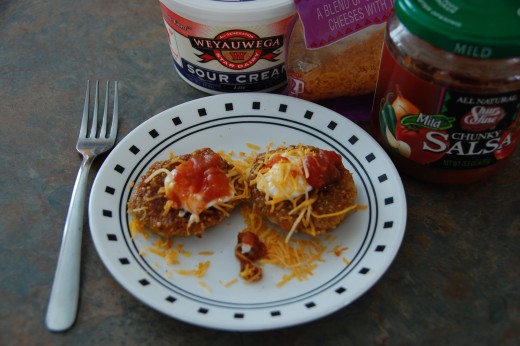 Quinoa taco patties, garnished with more cheese, sour cream and salsa, perfect!