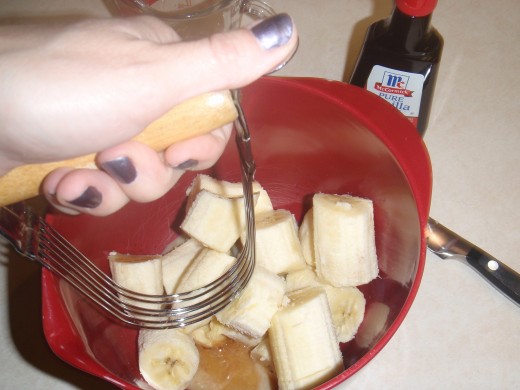 Mashing the bananas, vanilla and milk