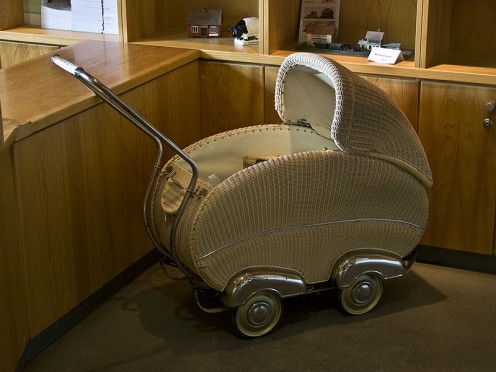 Beautifully crafted wicker pram with chrome 'hubcap' accents. probably 1950s .