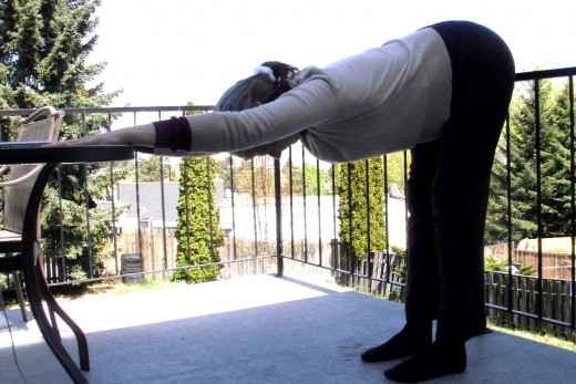 Downward Facing Dog with hands on your desk stretches the spine, the waist, the hamstrings, and releases tension.