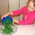 Grace adds the green beans to a bowl. Grace adds the green beans to a bowl.
