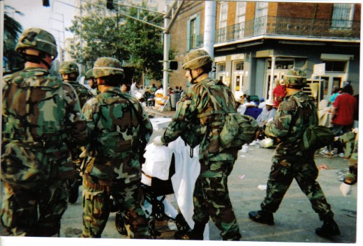 These Guard members are taking away the dead.