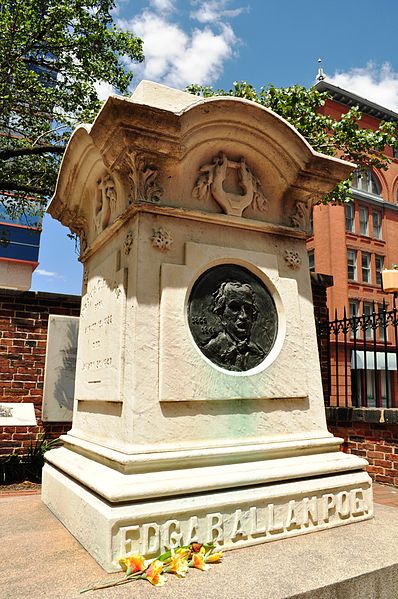 Edgar Allan Poe's grave marker in Westminster Hall and Burying Ground, Baltimore MD. Cognac and three roses sometimes appear at this site, but the media report that this is likely the work of a Poe Toaster copycat.