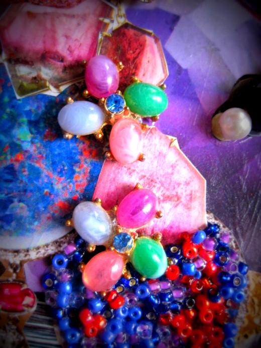 Beads and earrings adorn top of box.