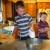 A little chef is a little upset that he has to take turns with the electric mixer. A little chef is a little upset that he has to take turns with the electric mixer.