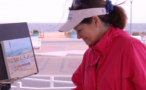 Plein Air Coastal Delaware artist, Christine Heyse, painting a Rehoboth Beach Boardwalk  scene.