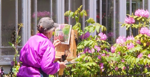 The house Mary is painting is across the street. The house visible in this photo was what she was using to partially shield her easel from the wind. 