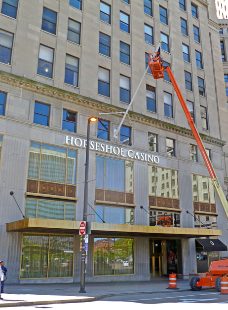 Workers add a flag over the Public Square entrance