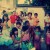 Neighbourhood kids along with their mothers waiting for "Little Santa" to hand out the gifts some wrapped in Christmas wrapping and some ready in plastic bags. Neighbourhood kids along with their mothers waiting for "Little Santa" to hand out the gifts some wrapped in Christmas wrapping and some ready in plastic bags.