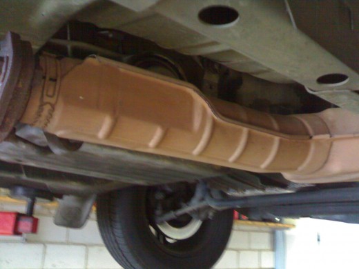 Although this looks rusty, it is just discolored because it is the front muffler close to the catalytic converter (which cleans the emission from the exhaust system)It is close to the very hot exhaust manifold on the cylinder head of the motor. This 