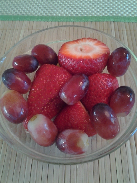 bowl with fresh strawberries and grapes