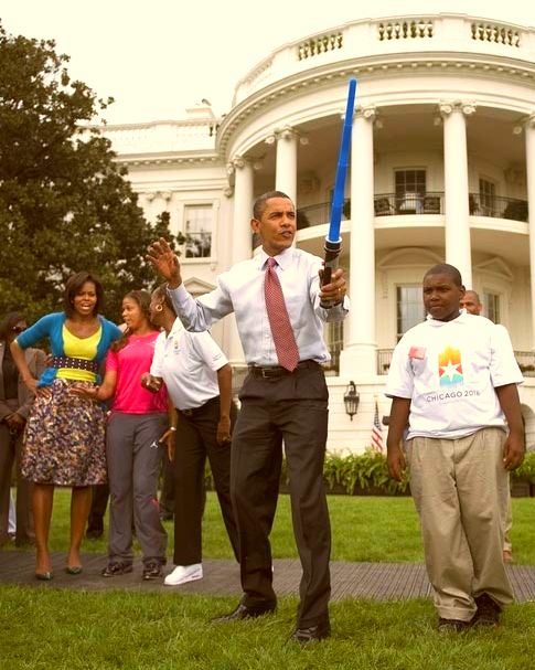 President Obama wields a light sabre in this candid photo.