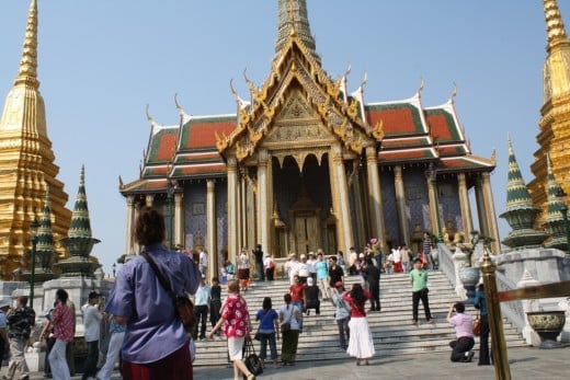 Men and women from different walks of life wondering about Thai architecture. 