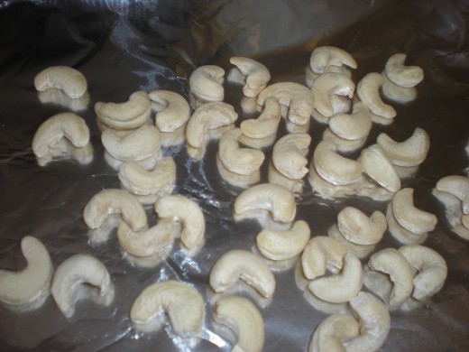 Raw cashews on a cookie sheet