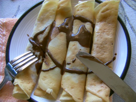 Easy crepes recipe. Crepes with strawberry jam and chocolate syrup. 