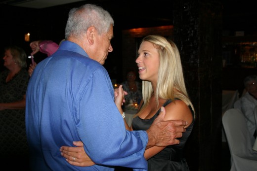 Grandfather and granddaughter dancing.