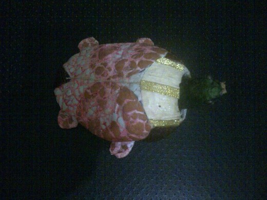 A turtle that has a wiggling head upon touches and wind blows . A turtle that has a wiggling head upon touches and wind blows .