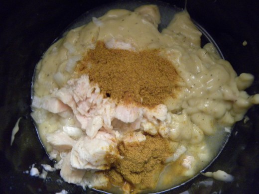 Chicken, cream of chicken soup, onions and curry powder in the crock pot ready to simmer for several hours. Sour cream is added the last 30 minutes. 