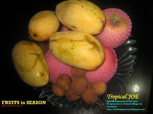 Fruits-in-season: a tray of Philippine mangoes with apples and lychees.