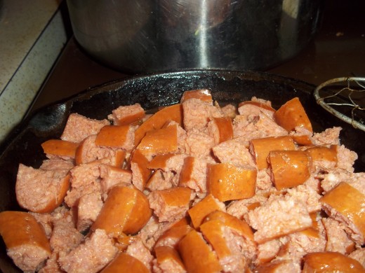 Browning sausage in cast iron skillet while rice cooks.
