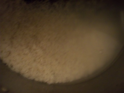 Cook rice according to package. Use long grain white rice if your budget allows. With all the stirring, the long grain holds up better