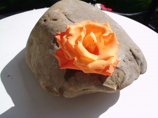 Zen Rock Wedding Table Décor. River rock and single, very open flowers