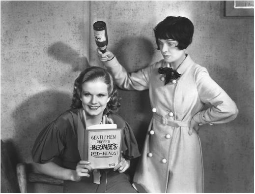 Jean Harlow reading Gentlemen Prefer Blondes, and being watched by the brunette author Anita Loos