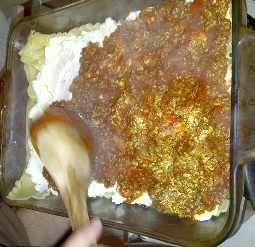 Adding layer of meat sauce