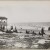 Title: On the Beach in Coney Island Date: 1895 Comments: View of people on the beach at Coney Island.  A pavilion is visible to the left. 