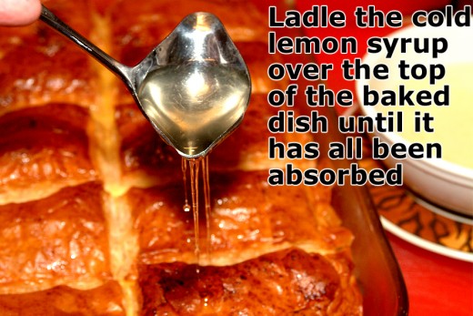 Slowly pour the lemon syrup over the baked dessert until it has all been absorbed.
