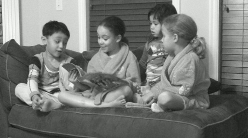 My oldest daughter reading a bedtime story to her sister and cousins.