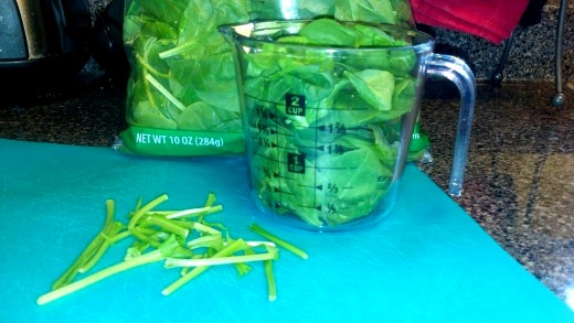 Pull the stems off the spinach leaves and fill up a 2 cup container.