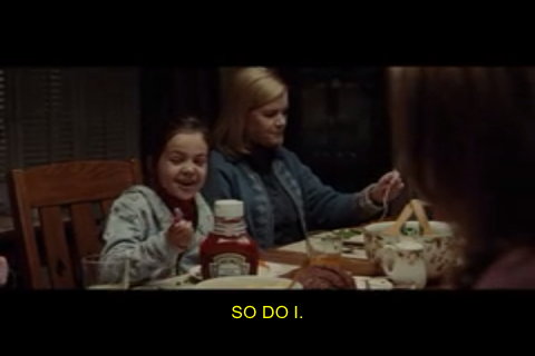 The closed captioning appears in the form of yellow text in the lower-center part of the screen.