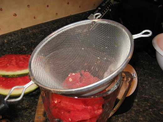 Strain watermelon juice into blender or food processor.