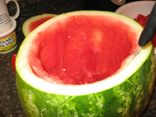 Decrease thickness of rind around top edge of shell to make watermelon carving easier. 