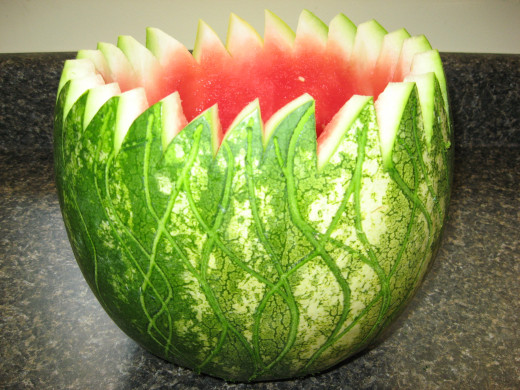 When ready to serve, add crushed ice to melon punch bowl.