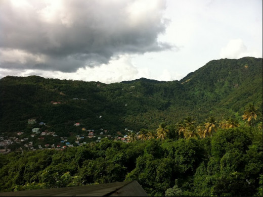 From the zip line  platforms at  Morne Coubaril Estate, visitors see the distant coastal village of Soufriere backed by densly jungled hills.