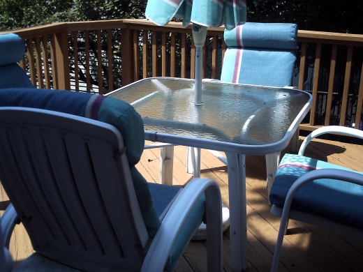 Table and Chairs back on the newly stained deck