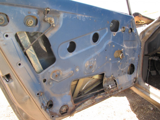 The driver's side door with the door panel removed.